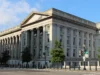 Why rich governments are paying more to borrow, and who feels it Wide view of the long colonnaded granite facade of the US Treasury Building under a blue sky, with trees and a street in front