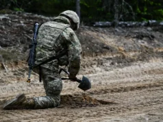Finland destroyed a million landmines. Why does it want them back? A soldier kneels on a sandy forest track, burying a mine with a small shovel