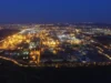 Why diesel remains scarce as crude exports recover Aerial night view of a sprawling oil refinery glowing with orange and white lights under a deep blue sky